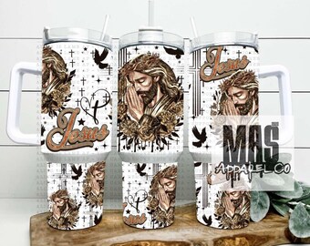 May include: White tumbler with a handle featuring a religious design. The design includes a man with a crown of thorns, the word "Jesus" and a cross. The tumbler is decorated with a white and black pattern.