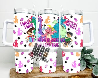 May include: A white ceramic mug with a black handle and the text "But First, Coffee" in a handwritten style. The mug is on a white surface. The mug is approximately 4 inches tall.