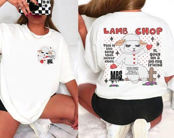 May include: White t-shirt featuring a cartoon lamb graphic with the text "LAMB CHOP" and "This is the song that never ends." The shirt has a crew neck and short sleeves. The design includes red and black accents.
