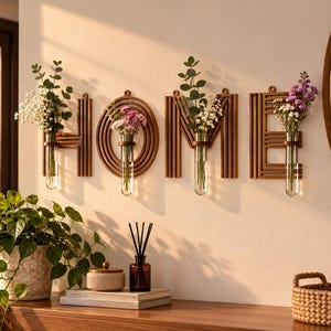 May include: A set of four wall-mounted wooden letters spelling HOME, each featuring a clear glass test tube vase. The letters are crafted from layered brown wood strips and contain small bouquets of white, green, and purple flowers.