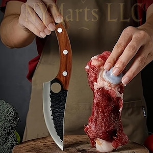 May include: A close-up of a butcher knife with a wooden handle and a serrated blade. The knife is being used to cut a piece of raw meat.