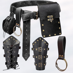 May include: A black leather belt with a pouch, a small bag, and two arm guards. The belt has a buckle and is decorated with metal studs. The pouch and bag have a flap closure and are also decorated with metal studs. The arm guards have straps and buckles.