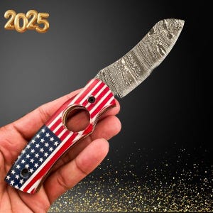 May include: A folding knife with a red, white, and blue American flag pattern on the handle. The blade is made of Damascus steel and has a curved shape.