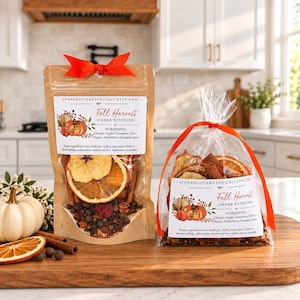 May include: Two pouches of Fall Harvest simmer potpourri with orange ribbons. The left pouch is brown paper, the right is clear plastic. Both feature white labels with pumpkin illustrations, ingredient lists, and the text StonehouseBotanicals.etsy.com.
