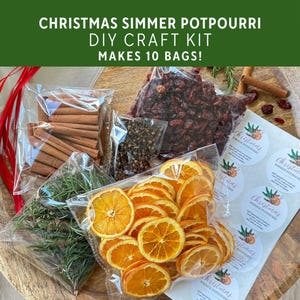 May include: A Christmas simmer potpourri DIY craft kit containing clear plastic bags filled with dried orange slices, cinnamon sticks, dried cranberries, cloves, and rosemary sprigs, plus a sheet of circular labels with the text Christmas Simmer Potpourri.
