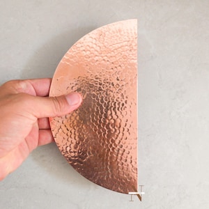 May include: A white ceramic mug adorned with a vibrant floral pattern. The design showcases pink, purple, and yellow flowers with green foliage. The mug has a classic, curved handle.