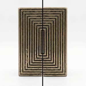 May include: A rectangular brass cabinet pull featuring a series of concentric, raised rectangular ridges that create a stepped, geometric pattern. The metal surface has a dark, aged patina with visible texture within the recessed channels.