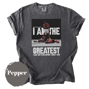 May include: A white ceramic mug with a black handle and the text "But first, coffee" in a handwritten style. The mug is on a white surface. The mug is 4 inches tall.