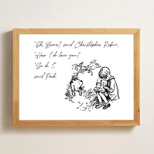May include: A framed print featuring a black and white illustration of Christopher Robin reading a book with Pooh Bear. The text reads "Oh, Bear!" said Christopher Robin. "How I do love you!" "So do I," said Pooh.