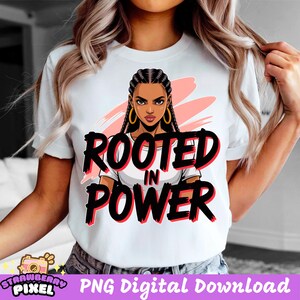 May include: White t-shirt with the words "ROOTED IN POWER" in black and red, featuring an illustration of a woman with braided hair and gold hoop earrings. The design includes a pink background.