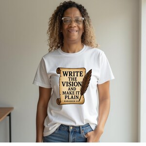 May include: White t-shirt with a brown scroll design that says "Write the Vision and Make it Plain, Habakkuk 2:2".