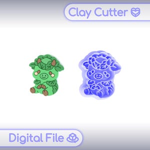 May include: Two clay cutters, one green and one blue, shaped like a cartoon sheep. The green sheep is a finished product, while the blue one is the cutter. The text "Clay Cutter" and "Digital File" are displayed.
