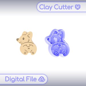 Puede incluir: Un cortador de arcilla en forma de corgi de color beige y un cortador de arcilla en forma de corgi azul. El corgi beige es un producto terminado, mientras que el azul es el cortador. El texto "Clay Cutter" y "Digital File" son visibles.