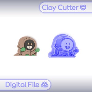 Peut inclure: Deux emporte-pièces en argile en forme de personnage de dessin animé. L'un est marron avec des détails verts, l'autre est bleu. Le texte "Clay Cutter" et "Digital File" est visible.
