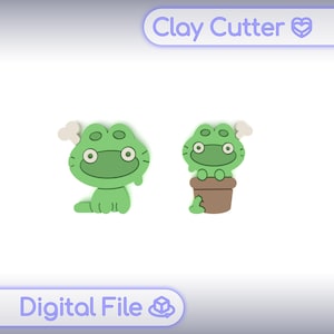 May include: Two green frog-shaped clay cutters. One frog is sitting, and the other is in a brown pot. The cutters have white eyes and a white cloud-like shape on their heads. The text "Clay Cutter" and "Digital File" are in the image.