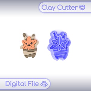May include: A blue clay cutter and a finished clay figure. The clay cutter is shaped like a cartoon character with a maple leaf head. The finished clay figure is tan, orange, and brown. The text "Clay Cutter" and "Digital File" are visible.
