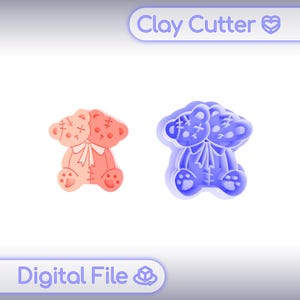 May include: A two-headed teddy bear clay cutter design featuring stitched details and a central bow. The image displays a coral-colored bear shape on the left and a blue 3D-printed cutter on the right, with text reading Clay Cutter and Digital File.