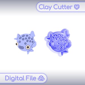 May include: Two blue clay cutters in the shape of a pufferfish. One is a solid shape, and the other is a cutter outline. The cutters have round eyes and spots. The text "Clay Cutter" and "Digital File" are in the image.