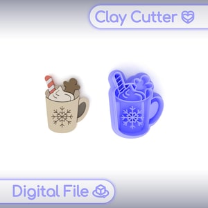 May include: Two clay cutters in the shape of a hot chocolate mug with a snowflake design. One is a finished product with a candy cane and gingerbread man. The other is a blue cutter. The text "Clay Cutter" and "Digital File" are visible.