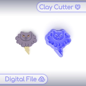 May include: Two clay cutters in the shape of a cat with a cloud and lightning bolt design. One is a finished product in gray and yellow, the other is a blue mold. The text "Clay Cutter" and "Digital File" are visible.