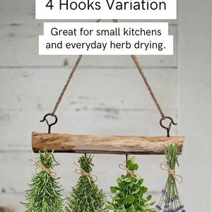 May include: A hanging herb drying rack featuring a natural light brown wooden branch suspended by a jute rope. The rack includes four metal hooks, each holding a bundle of fresh herbs tied with twine. Text reads: 4 Hooks Variation. Great for small kitchens and everyday herb drying.
