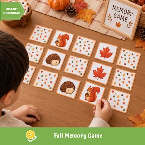 May include: A seasonal memory game consisting of square cards decorated with illustrations of squirrels, hedgehogs, maple leaves, and autumn foliage patterns. A wooden sign shows the text Memory Game, with cards laid out on a wooden surface.