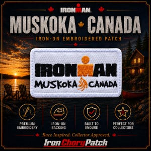 May include: A rectangular white iron-on embroidered patch featuring the black text IRONMAN and MUSKOKA CANADA. The design includes an orange M-dot logo and an orange stylized flame graphic. The patch has a white stitched border on a white background.