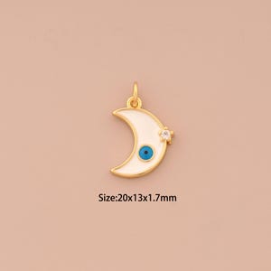 May include: Gold crescent moon charm with a blue evil eye and a clear rhinestone. Size: 20x13x1.7mm.