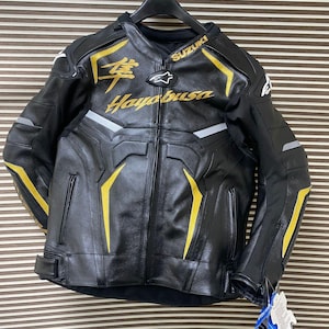 May include: Black leather motorcycle jacket with yellow accents and the text "Suzuki Hayabusa" in gold lettering.