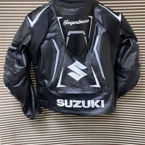 May include: Black leather motorcycle jacket with white accents and the words "Hayabusa" and "SUZUKI" on the back.