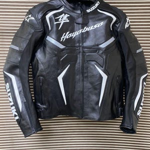 May include: Black leather motorcycle jacket with white accents and the text "Suzuki Hayabusa" on the front.