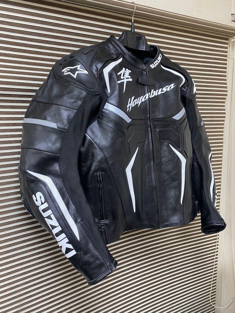 May include: Black leather motorcycle jacket with white accents and the text "Hayabusa" and "Suzuki" on the front and sleeves.