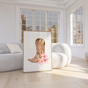 May include: A watercolor painting of a pair of brown cowboy boots with pink flowers. The boots are in a rustic style and the flowers are delicate and feminine.