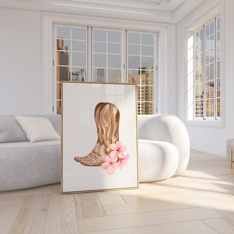 May include: A watercolor painting of a pair of brown cowboy boots with pink flowers. The boots are in a rustic style and the flowers are delicate and feminine.