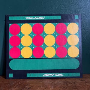 May include: A black board game with the text "COUNTER STRIKE" in white. The board features a grid of red and yellow circles, numbered from 1 to 18. The game board has green accents.