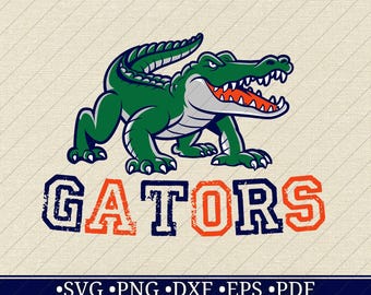 May include: A green alligator mascot with an open mouth and sharp teeth. The word "GATORS" is displayed in blue and orange, with a distressed font. Below, the image includes file type options: SVG, PNG, DXF, EPS, and PDF.