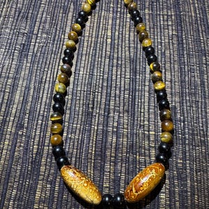 Obsidian, Tiger’s Eye, and Painted Wood beads necklace with double Lobster Clasps. 44cm.