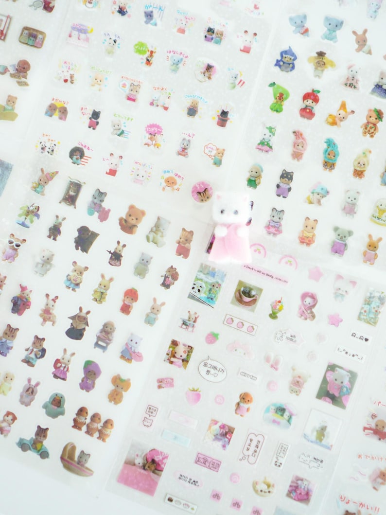 May include: A sheet of clear stickers featuring adorable cartoon animals, including bears, bunnies, cats, and more. The stickers are perfect for adding a touch of whimsy to planners, journals, and other craft projects.