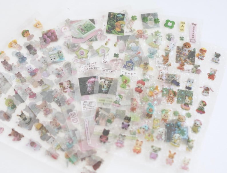 May include: A sheet of clear sticker paper with various colourful cartoon animal stickers. The stickers feature a variety of animals, including cats, dogs, rabbits, and birds. The stickers are perfect for adding a touch of whimsy to your planner, journal, or scrapbook.
