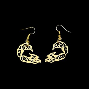 May include: A pair of gold-colored earrings with a unique, openwork design. Each earring features a stylized, curved shape with intricate swirling patterns and a fish hook style closure. The earrings are set against a black background.