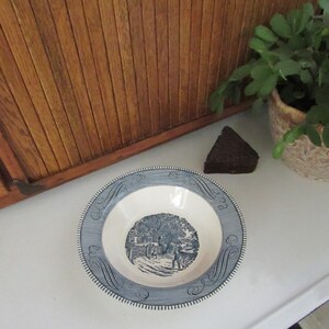 May include: A blue and white ceramic bowl with a blue and white floral design. The bowl is on a white surface.