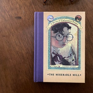 May include: A Series of Unfortunate Events book cover featuring a young boy with glasses and a bow tie. The book is titled "The Miserable Mill" and is the fourth book in the series by Lemony Snicket.