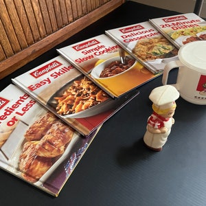 Vintage Campbell’s Soup Collection –Campbell’s Kid 1950s Celluloid Pepper Shaker, Set of 5 Campbell’s Cookbooks, Covered Campbell’s Soup Mug