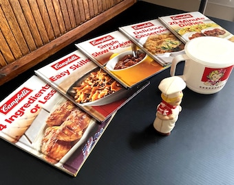Vintage Campbell’s Soup Collection –Campbell’s Kid 1950s Celluloid Pepper Shaker, Set of 5 Campbell’s Cookbooks, Covered Campbell’s Soup Mug