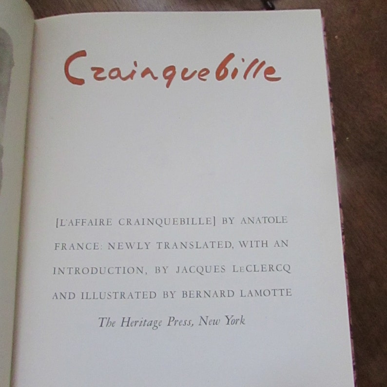 May include: A book titled "Crainquebille" by Anatole France. The book is newly translated with an introduction by Jacques Leclercq and illustrated by Bernard Lamotte. The book is published by The Heritage Press, New York.