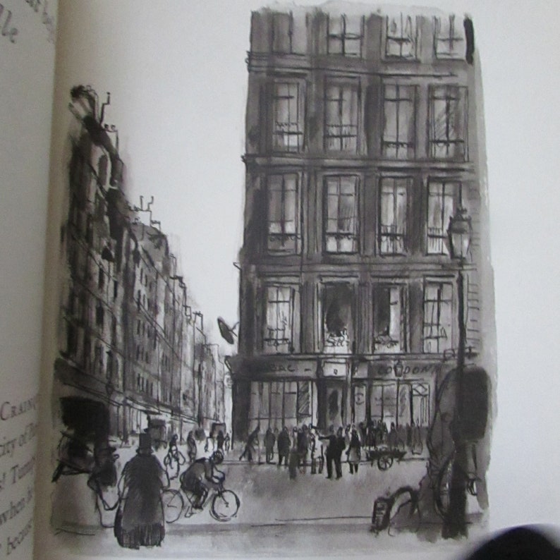 May include: A black and white ink drawing of a Parisian street scene. The drawing features a tall building with many windows, a street lined with buildings, and people walking on the sidewalk. The drawing is done in a realistic style.