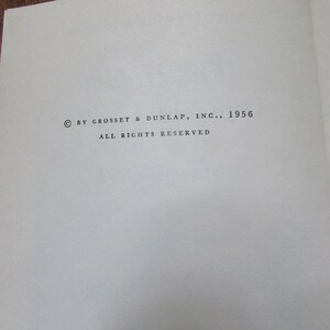 May include: Copyright notice for a book published by Grosset & Dunlap, Inc. in 1956. The text reads "&copy; BY GROSSET & DUNLAP, INC., 1956 ALL RIGHTS RESERVED".