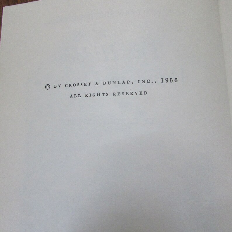 May include: Copyright notice for a book published by Grosset & Dunlap, Inc. in 1956. The text reads "&copy; BY GROSSET & DUNLAP, INC., 1956 ALL RIGHTS RESERVED".