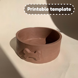 May include: A brown ceramic dog bowl with a bone-shaped design. The bowl is empty and ready for food or water.