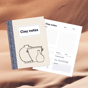 May include: A white notebook with the text "Clay notes" on the cover. The notebook has a blue and white striped border. The notebook is open to a page with a drawing of three pottery pieces and a section for notes.